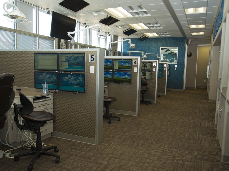 Stone Oak Orthodontics treatment area in San Antonio – multiple dental stations with modern technology in LEED-certified office renovation.