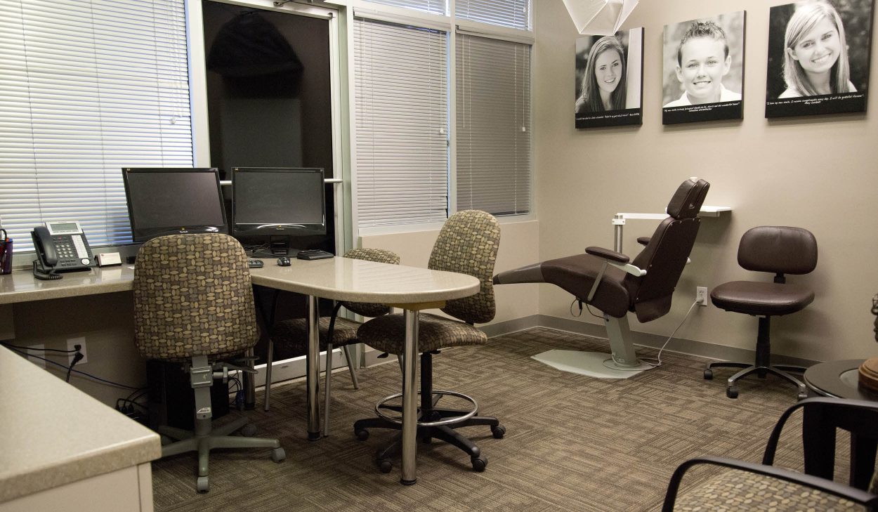 Stone Oak Orthodontics consultation room with dental chair, computers, and wall art in San Antonio healthcare renovation.