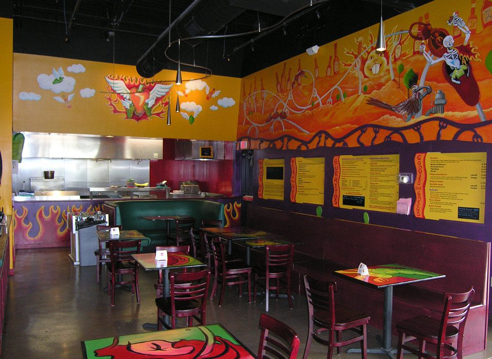 Alt tag: Dining area of Habanero’s Grill showcasing vibrant wall art, menu boards, and seating arrangements.