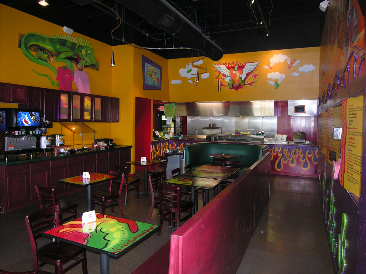 habaneros2 Alt tag: Interior view of Habanero’s Grill in San Antonio featuring colorful murals, booth seating, and open kitchen design.