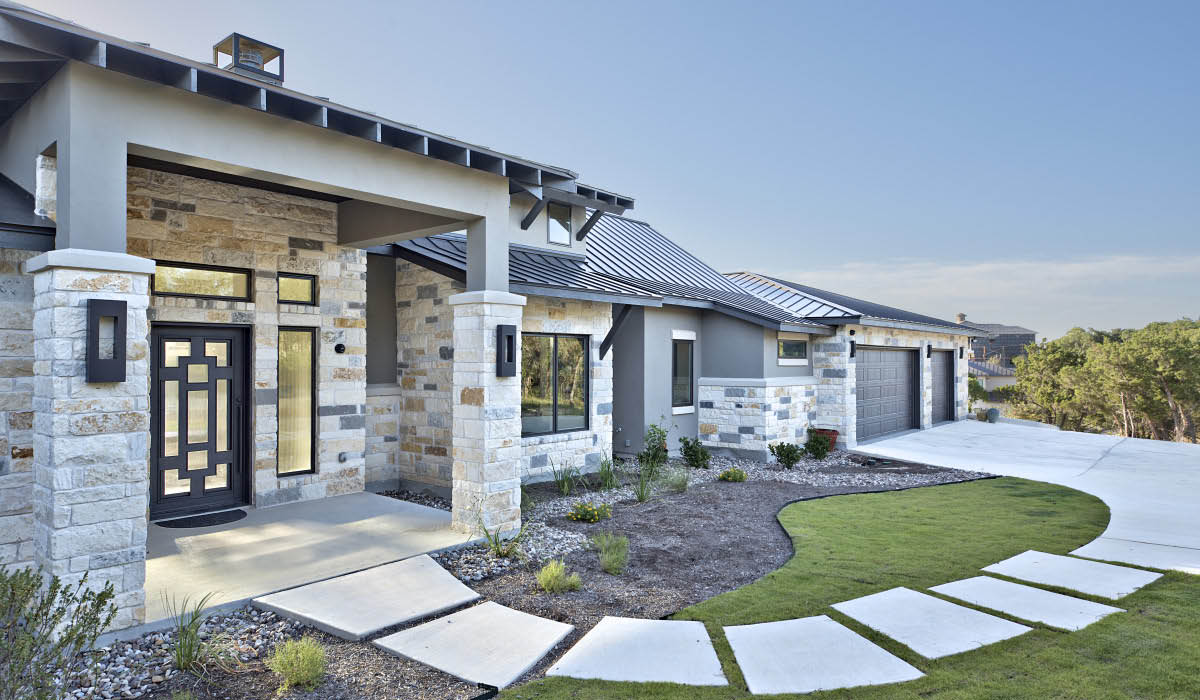 Front elevation showcasing stone and stucco finishes at Hill Country home Plan 4690