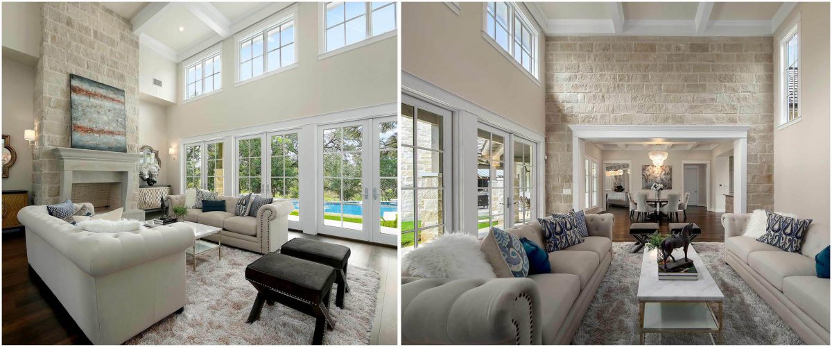 Spacious living room with double-height windows, stone fireplace, and transitional French Country design