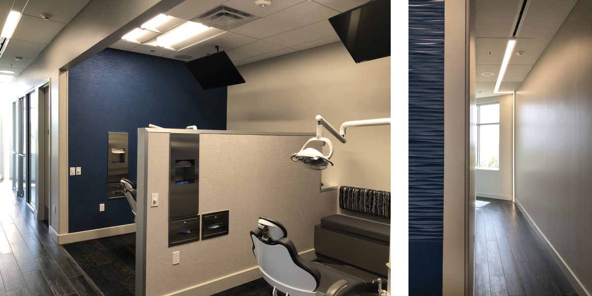 Private orthodontic treatment bay with patient chair, mounted lights, and blue accent wall